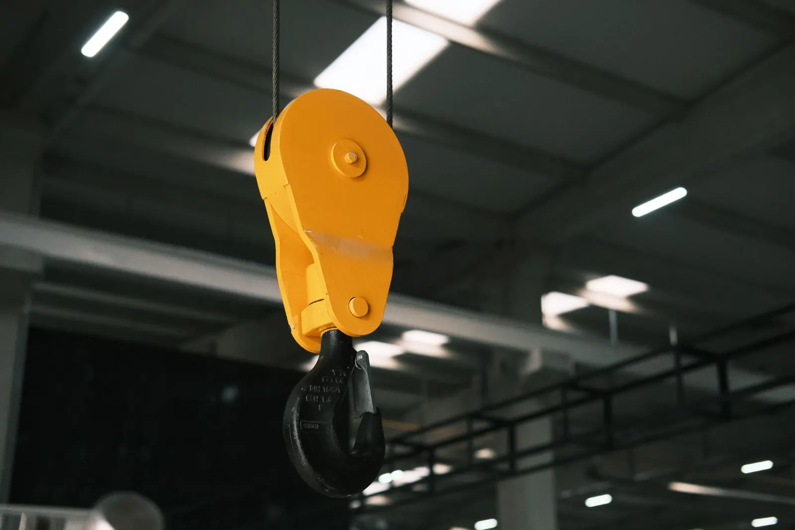Yellow crane hook in a workshop